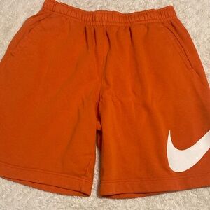 Nike Orange Athletic Shorts with White Swoosh